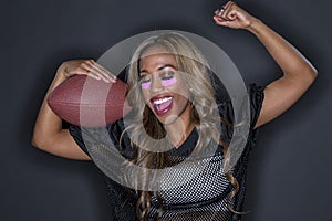 Beautiful African American Model Wearing A Football Helmet And Holding A Football