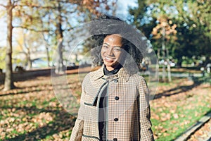 Beautiful African American woman in autumn park