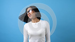 Beautiful African American woman dancing over blue background