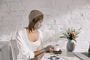 Beautiful african american woman holding cup