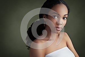 Beautiful african american woman looking at camera. Portrait of cheerful young woman with afro hairstyle. Beauty girl with curly h