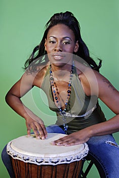 Beautiful African-American woman playing drums