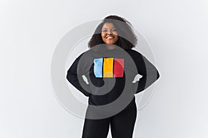 Beautiful African American woman posing in black sweatshirt on a white background. Street fashion photo with afro