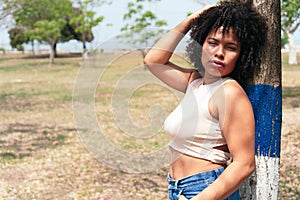 Beautiful African American Woman Posing In A Sunny Park