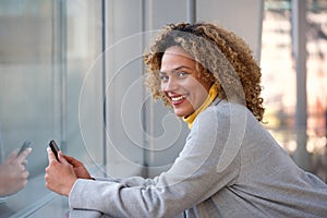 Beautiful african american woman smiling with smart phone