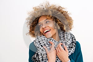 Beautiful african american woman smiling with winter coat against white background