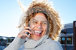 Beautiful african american woman talking on mobile phone and laughing