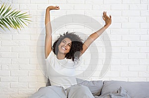 Beautiful black woman waking up in her bed