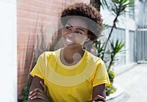 Beautiful african american woman in a yellow shirt