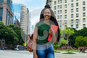 Beautiful african american young adult female student with braids