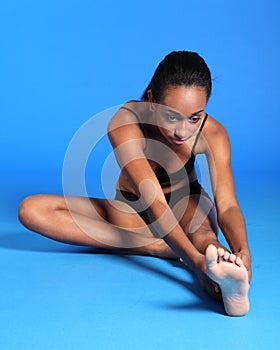 Beautiful African fitness woman hamstring stretch