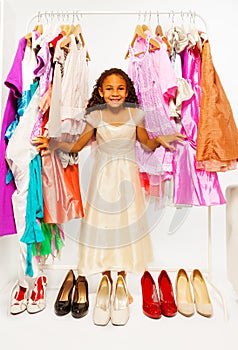 Beautiful African girl choosing clothes in shop
