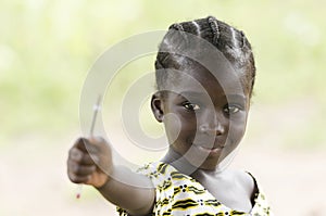 Beautiful African girl holding a pen outdoors