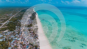 Beautiful African local settlement with colorful buildings next to blue ocean in Jambiani, Zanzibar photo