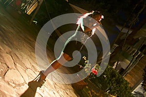 Beautiful African singer woman singing with colorful lights background with her microphone near her mouth