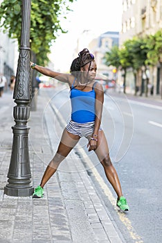 Beautiful african sport woman doing stretches, healthy lifestyle