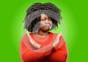 Beautiful african woman with curly hair isolated over green background photo