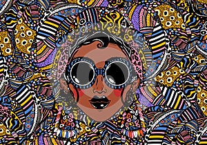 Beautiful African woman in cool urban style with ethnic elegant geometric glasses, earrings on a rythmic background.