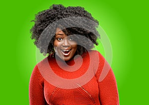 Beautiful african woman with curly hair isolated over green background