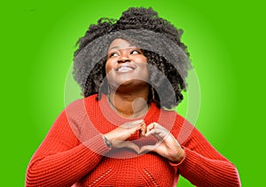 Beautiful african woman with curly hair isolated over green background