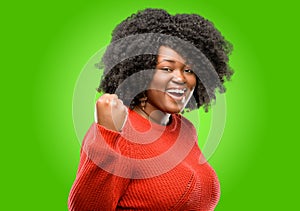 Beautiful african woman with curly hair isolated over green background