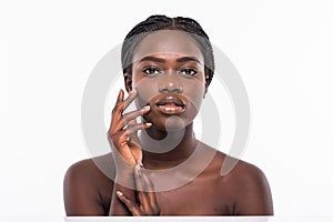 Beautiful african woman face close up portrait studio on white background