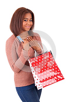 Beautiful african woman holding a credit card and shopping bags