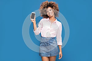 Beautiful african woman holding mobile phone and smiling.