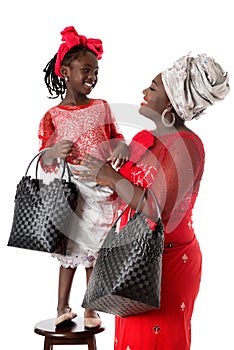 Beautiful African woman with little girl in traditional clothing