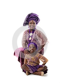 Beautiful African woman and lovely little girl in traditional dress.Isolated