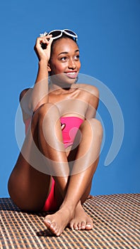 Beautiful african woman monokini swimsuit in sun photo
