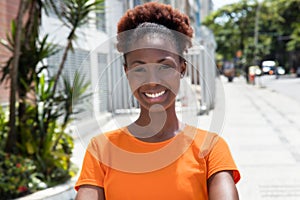 Beautiful african woman in a orange shirt