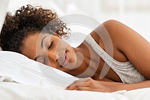 Beautiful african woman sleeping in bed