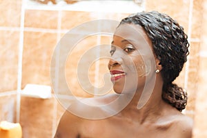 Beautiful African woman smiling with cream on her face