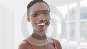 Beautiful African woman smiling and looking at camera indoor in the morning