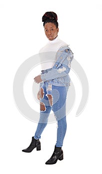 Beautiful African woman standing in jeans in the studio