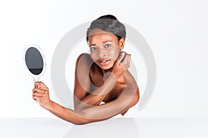 Beautiful African woman in Studio with mirror