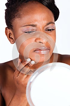 Beautiful African woman in Studio with mirror