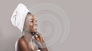 Beautiful african woman with towel on head and glowing skin