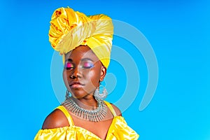 beautiful african woman in yellow silk turban on head and dress with silver neckless and earrings , nose piercing in