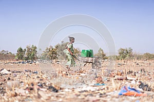 Beautiful African Women Bringing Clean Water for an insufficiency concept