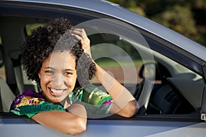 Beautiful African women leaning out of her car