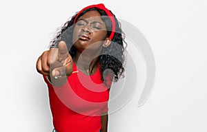 Beautiful african young woman wearing casual clothes pointing displeased and frustrated to the camera, angry and furious with you