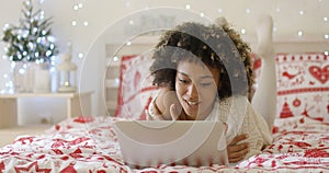 Beautiful Afro American girl lying on bed
