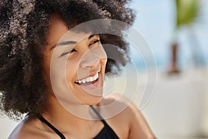 Beautiful afro american woman looking away laughing