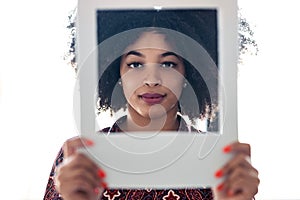 Beautiful afro business woman holding hands frame while posing to camera to snapshot in the office at home