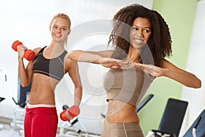 Beautiful afro girl exercising at the gym