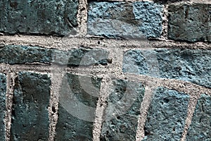 Beautiful aged and weathered blue brick wall surfaces in a close up view