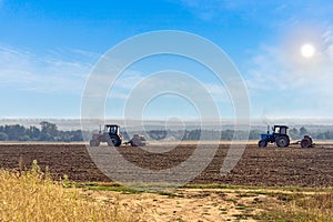Beautiful agricultural landscape with two old tractors equipped with seeders. photo