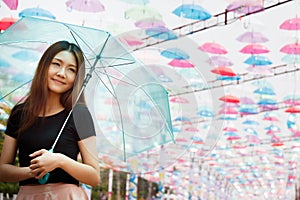 Beautiful Aisan girl with umbrellas